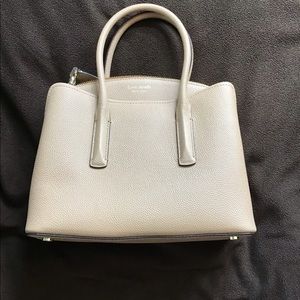 Preowned. Used once. Like new condition. Kate Spade beige purse.